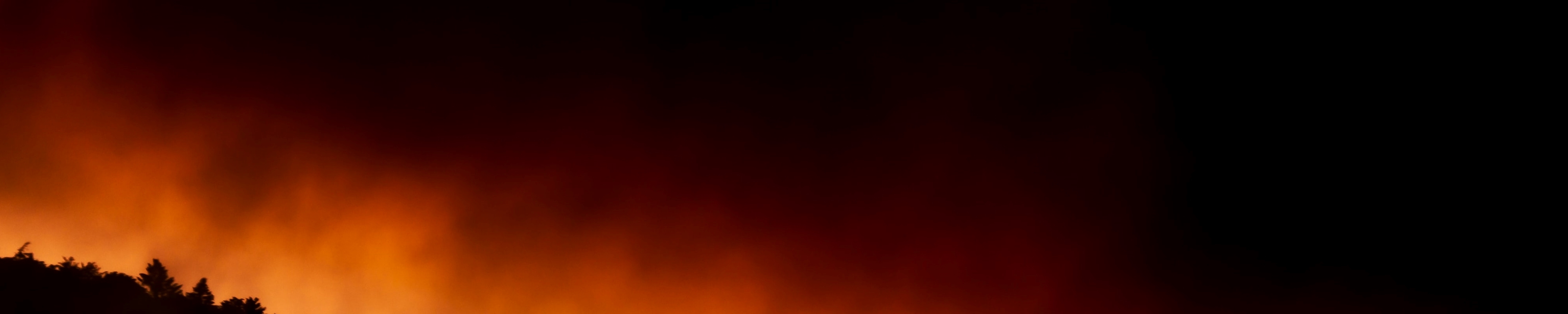 Mountains with the glow of a wildfire in the background. Original source: https://unsplash.com/photos/2kqXGRGUNzQ